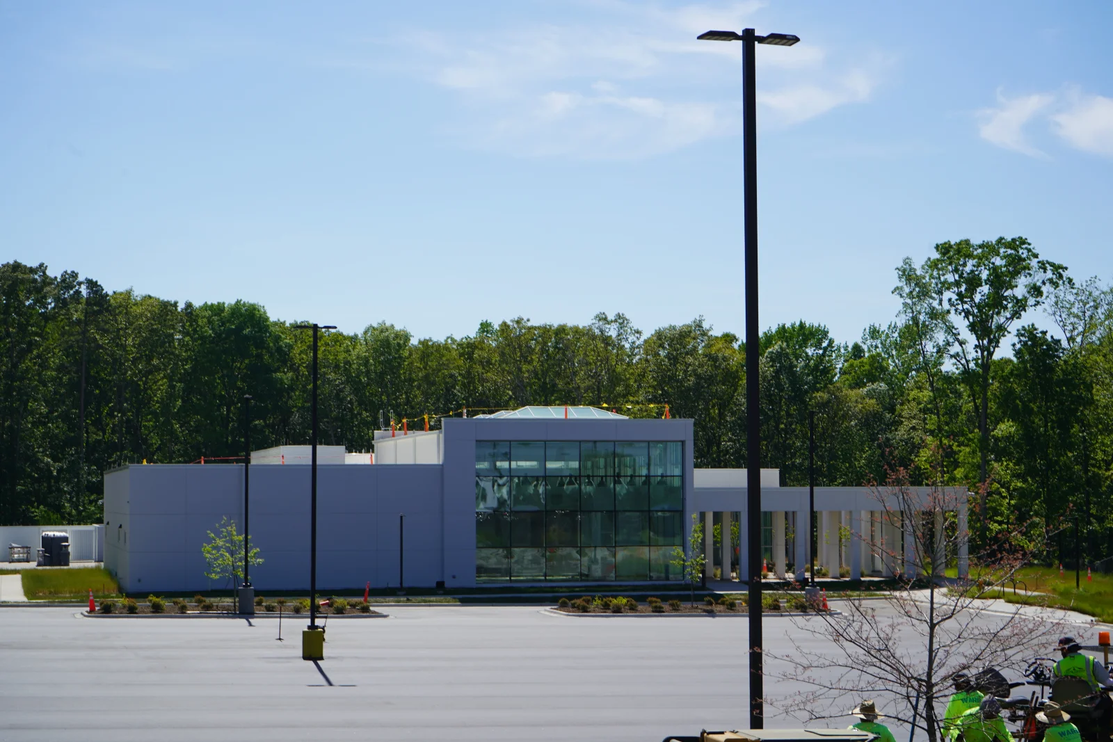 Finished asphalt parking lot with concrete curbing and landscape edging at commercial building